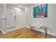 Inviting entryway with hardwood floors, coat closet, and a modern art piece at 3292 S Wabash Ct, Denver, CO 80231