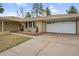 Brick house with attached garage and well-maintained lawn and landscape at 3292 S Wabash Ct, Denver, CO 80231
