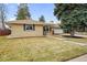 Well-kept ranch style home featuring a lush green lawn and mature trees at 3292 S Wabash Ct, Denver, CO 80231