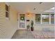 Charming entryway with wreath-adorned door, neat landscaping, and bright windows at 3292 S Wabash Ct, Denver, CO 80231
