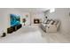 Spacious living room with a stone fireplace, large TV, and comfortable seating at 3292 S Wabash Ct, Denver, CO 80231