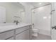 Modern bathroom featuring white tiled shower and a white vanity with black fixtures at 5773 N Jericho Way, Aurora, CO 80019