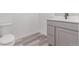 Powder room features modern toilet, vanity with white countertop and gray shaker cabinets at 5773 N Jericho Way, Aurora, CO 80019