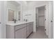 Modern bathroom featuring double vanity, tiled floor, and walk-in closet at 5773 N Jericho Way, Aurora, CO 80019