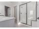 Modern bathroom with glass shower, gray vanity, and tile flooring at 5773 N Jericho Way, Aurora, CO 80019