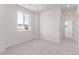 Bright bedroom with large window offering natural light and neutral carpeting at 5773 N Jericho Way, Aurora, CO 80019
