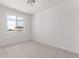 Well-lit bedroom featuring large windows providing ample natural light and neutral carpeting at 5773 N Jericho Way, Aurora, CO 80019