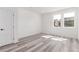 Bright bedroom with two windows, light-colored wood floors and fresh white paint at 5773 N Jericho Way, Aurora, CO 80019