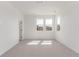 Spacious bedroom featuring three large windows and neutral carpeting at 5773 N Jericho Way, Aurora, CO 80019