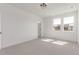 Large bedroom with carpet, bright windows, and white walls at 5773 N Jericho Way, Aurora, CO 80019