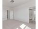 Bright bedroom with neutral carpet featuring ensuite bathroom and walk-in closet at 5773 N Jericho Way, Aurora, CO 80019