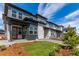 Contemporary townhomes showcasing gray siding, stone details, and well-maintained landscaping at 5773 N Jericho Way, Aurora, CO 80019