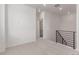 Hallway featuring neutral carpeting, leading to an adjacent bathroom and bedroom at 5773 N Jericho Way, Aurora, CO 80019