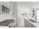 Well-equipped kitchen with stainless steel appliances, gray cabinets, and a breakfast bar at 5773 N Jericho Way, Aurora, CO 80019