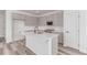 Modern kitchen with gray cabinets, white countertops, stainless steel appliances, and an island at 5773 N Jericho Way, Aurora, CO 80019