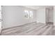 Bright living room with stylish wood flooring, white walls, and ample natural light at 5773 N Jericho Way, Aurora, CO 80019