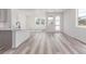 Open concept living area with modern floors, neutral paint, and bright natural light at 5773 N Jericho Way, Aurora, CO 80019