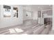 Bright, open living area with new wood floors and a view of the kitchen with white island at 5773 N Jericho Way, Aurora, CO 80019