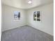 Bright bedroom featuring plush carpet, fresh white paint and two large windows at 9400 High St, Thornton, CO 80229