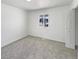 Bright bedroom with soft grey carpet, fresh white paint, large window and a closet at 9400 High St, Thornton, CO 80229