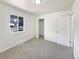 Bright bedroom featuring plush carpet, fresh white paint, closet and large window at 9400 High St, Thornton, CO 80229