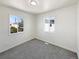 Bright bedroom featuring plush carpet, fresh white paint and two large windows at 9400 High St, Thornton, CO 80229