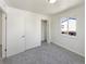 Bright bedroom featuring plush carpet, fresh white paint, large window and closet at 9400 High St, Thornton, CO 80229