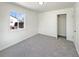 Bright bedroom with neutral carpet and a large window for natural light at 9400 High St, Thornton, CO 80229