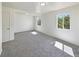 Large bonus room featuring fresh white paint, soft grey carpet, recessed lights, and dual windows at 9400 High St, Thornton, CO 80229