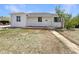 Charming one-story home with white siding, brick accents, and a well-manicured front yard at 9400 High St, Thornton, CO 80229