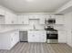 Modern kitchen with stainless steel appliances, white cabinets, and bright countertops at 9400 High St, Thornton, CO 80229