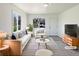 Bright living room with stylish furniture, a striped rug, and plenty of natural light at 9400 High St, Thornton, CO 80229