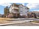 This is an exterior shot of a two-story condominium complex with brick accents and multiple balconies on the upper floors at 12820 Ironstone Way # 301, Parker, CO 80134