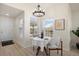 Bright dining area with a modern chandelier and views from two large windows at 12820 Ironstone Way # 301, Parker, CO 80134
