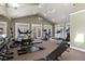 Bright and spacious gym with treadmills, weights, and various exercise machines with multiple windows and ceiling fans at 12820 Ironstone Way # 301, Parker, CO 80134
