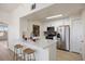 Bright kitchen features a breakfast bar with quartz counters and stainless steel appliances at 12820 Ironstone Way # 301, Parker, CO 80134