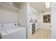 Laundry room with a washer and dryer, shelving, and adjacent to the kitchen at 12820 Ironstone Way # 301, Parker, CO 80134