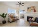 Cozy living room with fireplace, large window and sliding doors to the exterior deck at 12820 Ironstone Way # 301, Parker, CO 80134