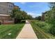 Scenic walking path winding through well-manicured lawns and lush landscaping within the residential community at 12820 Ironstone Way # 301, Parker, CO 80134