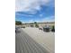 Outdoor deck featuring white railing, fire pit, chairs, and beautiful blue sky at 58117 E 42Nd Dr, Strasburg, CO 80136