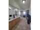 Bright bathroom with double vanity and shower, providing functionality and style at 58117 E 42Nd Dr, Strasburg, CO 80136
