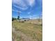 Exterior view of a blue home with a large, partially fenced yard at 58117 E 42Nd Dr, Strasburg, CO 80136