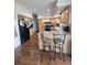 Well-lit kitchen featuring wood cabinets, laminate countertops, and stainless steel appliances, with an island bar at 58117 E 42Nd Dr, Strasburg, CO 80136