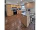 This kitchen features wood cabinets, laminate countertops, modern appliances, and an island with seating at 58117 E 42Nd Dr, Strasburg, CO 80136