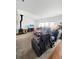 Cozy living room with a wood-burning stove, plush seating, and natural light at 58117 E 42Nd Dr, Strasburg, CO 80136