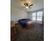 Cozy main bedroom with carpeted floors, ceiling fan, and ample natural light at 58117 E 42Nd Dr, Strasburg, CO 80136