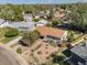 Overhead view of a quaint single-story home featuring mature trees, fenced backyard, and manicured xeriscaped yard at 1568 S Osceola Way, Denver, CO 80219