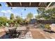 Spacious backyard deck with outdoor furniture, grill, and beautiful landscaping for entertaining at 1568 S Osceola Way, Denver, CO 80219