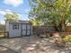 Backyard featuring a well-maintained storage shed with stepping stones and a relaxing lounge chair at 1568 S Osceola Way, Denver, CO 80219