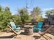 Cozy outdoor patio with stone fire pit and Adirondack chairs for relaxing evenings at 1568 S Osceola Way, Denver, CO 80219